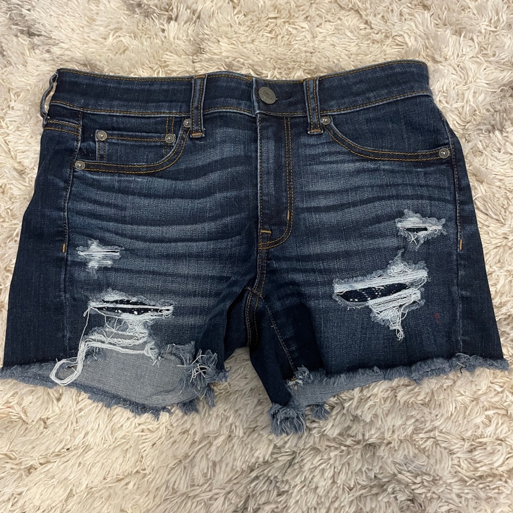 Dark jean shorts from American Eagle with blue laced pockets(Next level stretch)